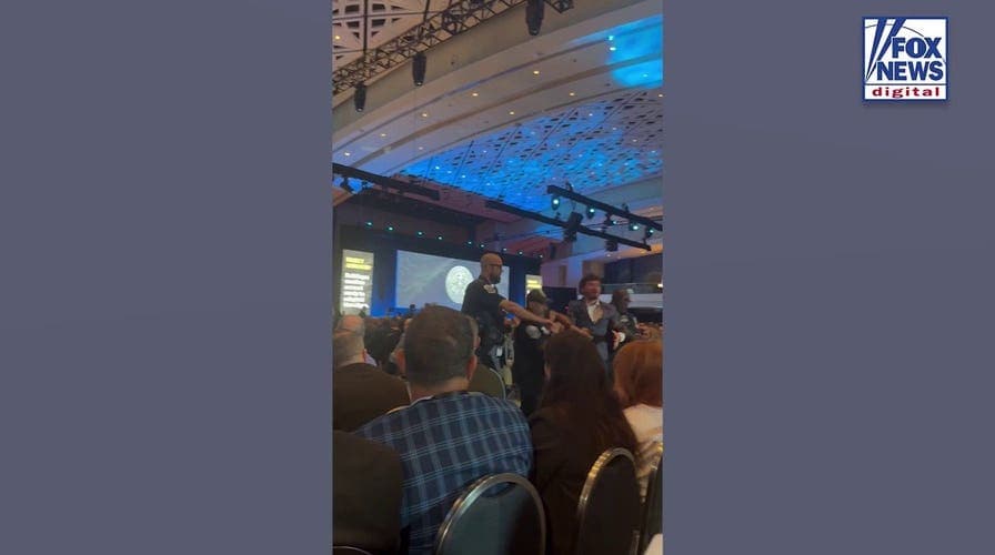WATCH: Protesters dragged from room after interrupting Hegseth during military panel