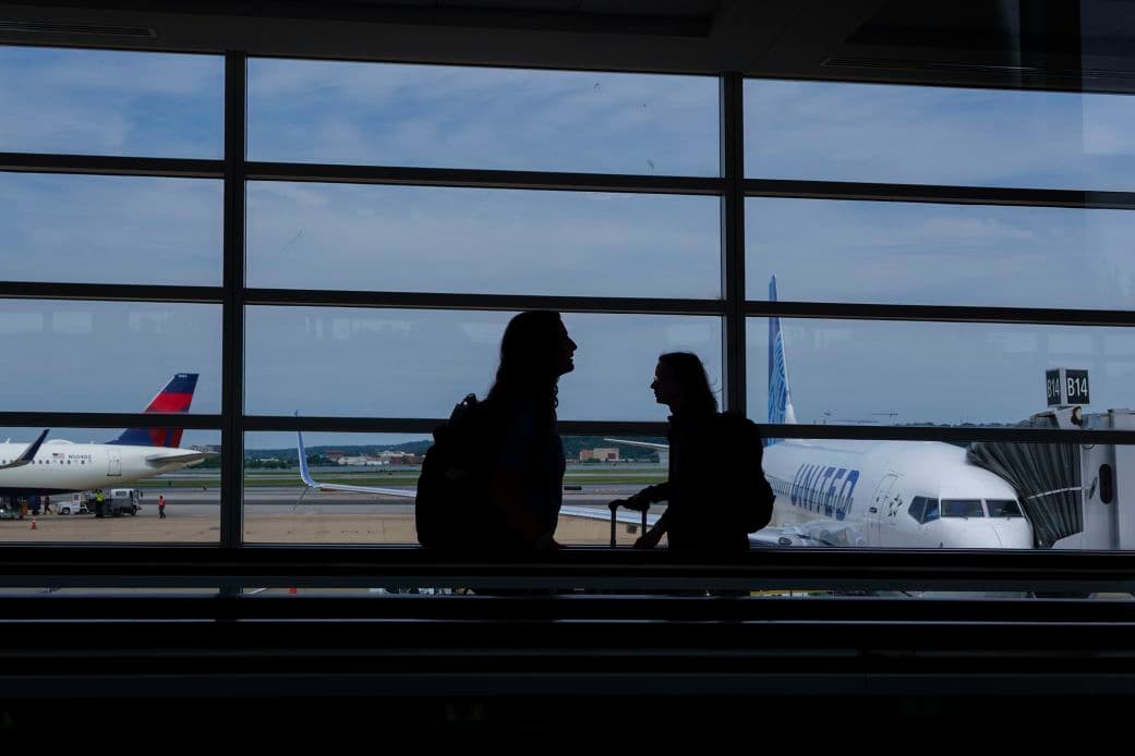 Passengers walk through the terminal at Ronald Reagan Washington National Airport on June 9, 2026, in Arlington, Virginia.